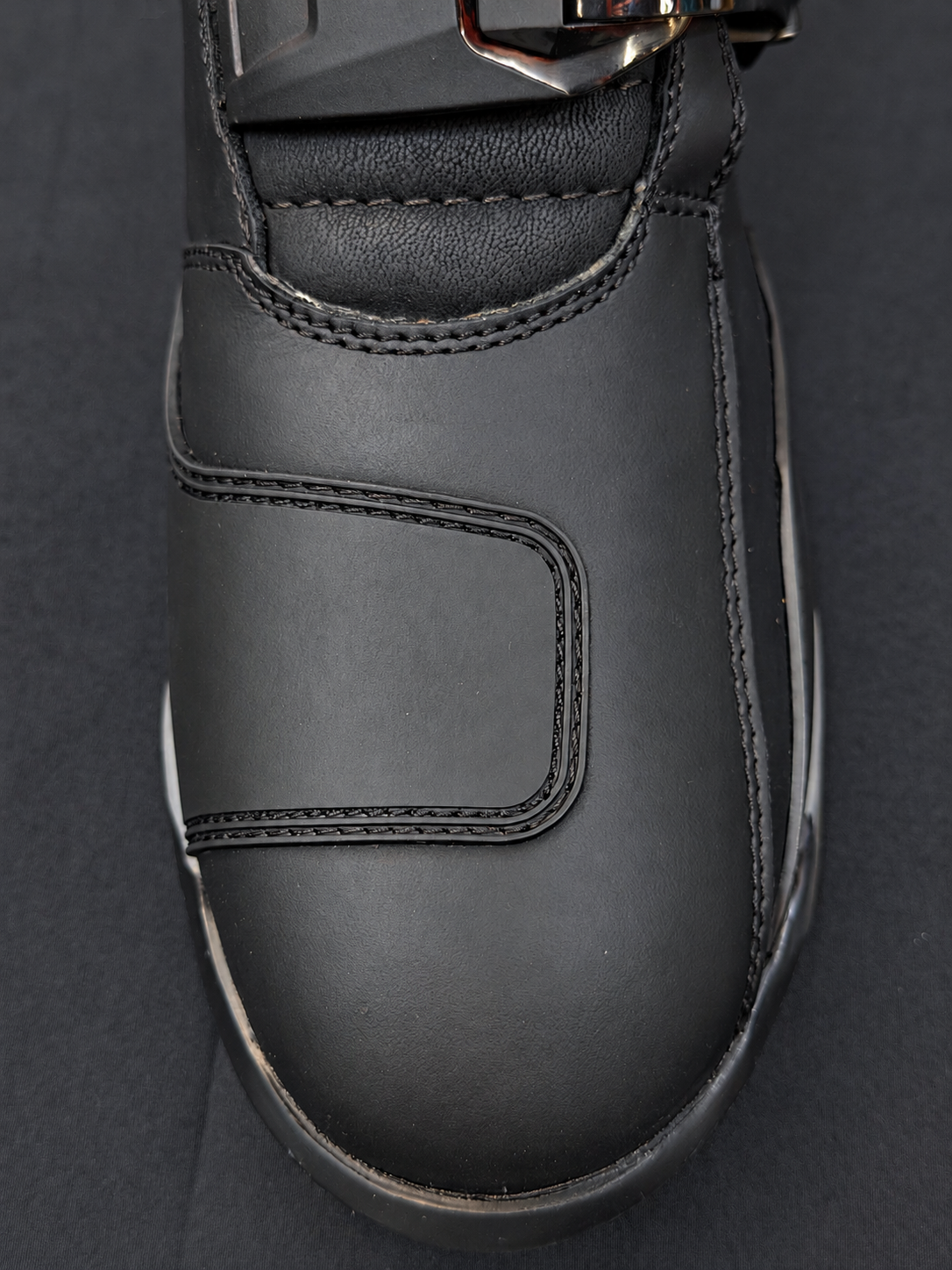 Top view of a black Royal Enfield Wanderer riding boot showing the stitched toe panel and padded instep.