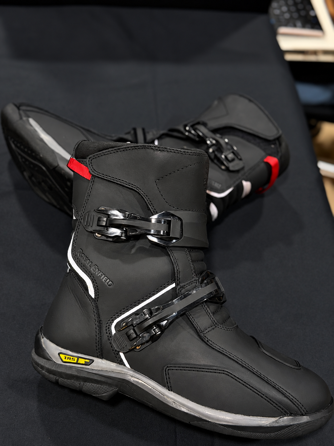 Pair of black Royal Enfield Wanderer waterproof riding boots, showing twin buckle fastenings and stitched toe panels.