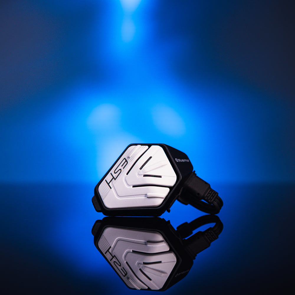 BluArmor HS3 silver and black device reflected on a glossy surface under blue lighting