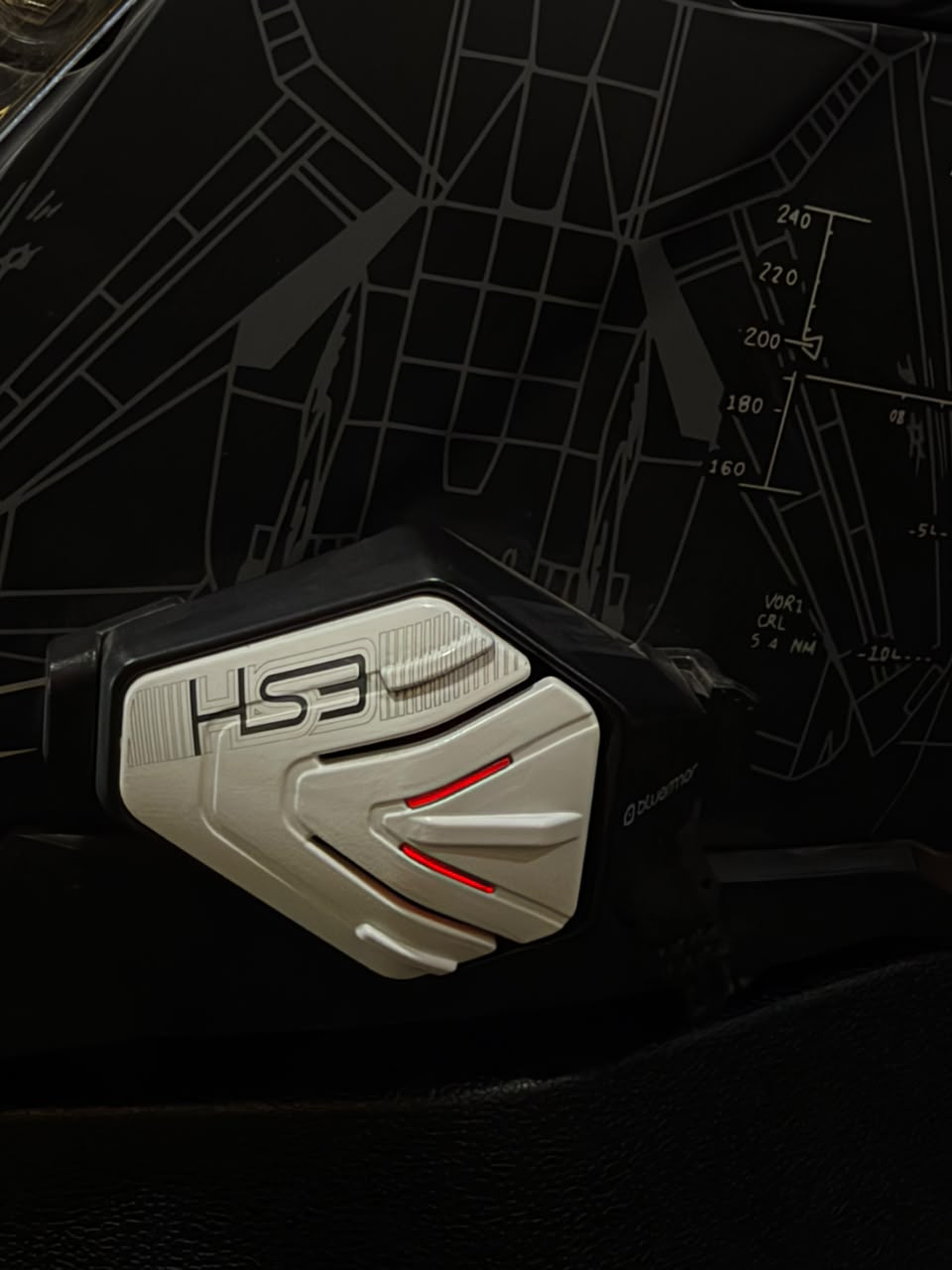 BluArmor HS3 silver faceplate with red indicator lights against a dark patterned backdrop