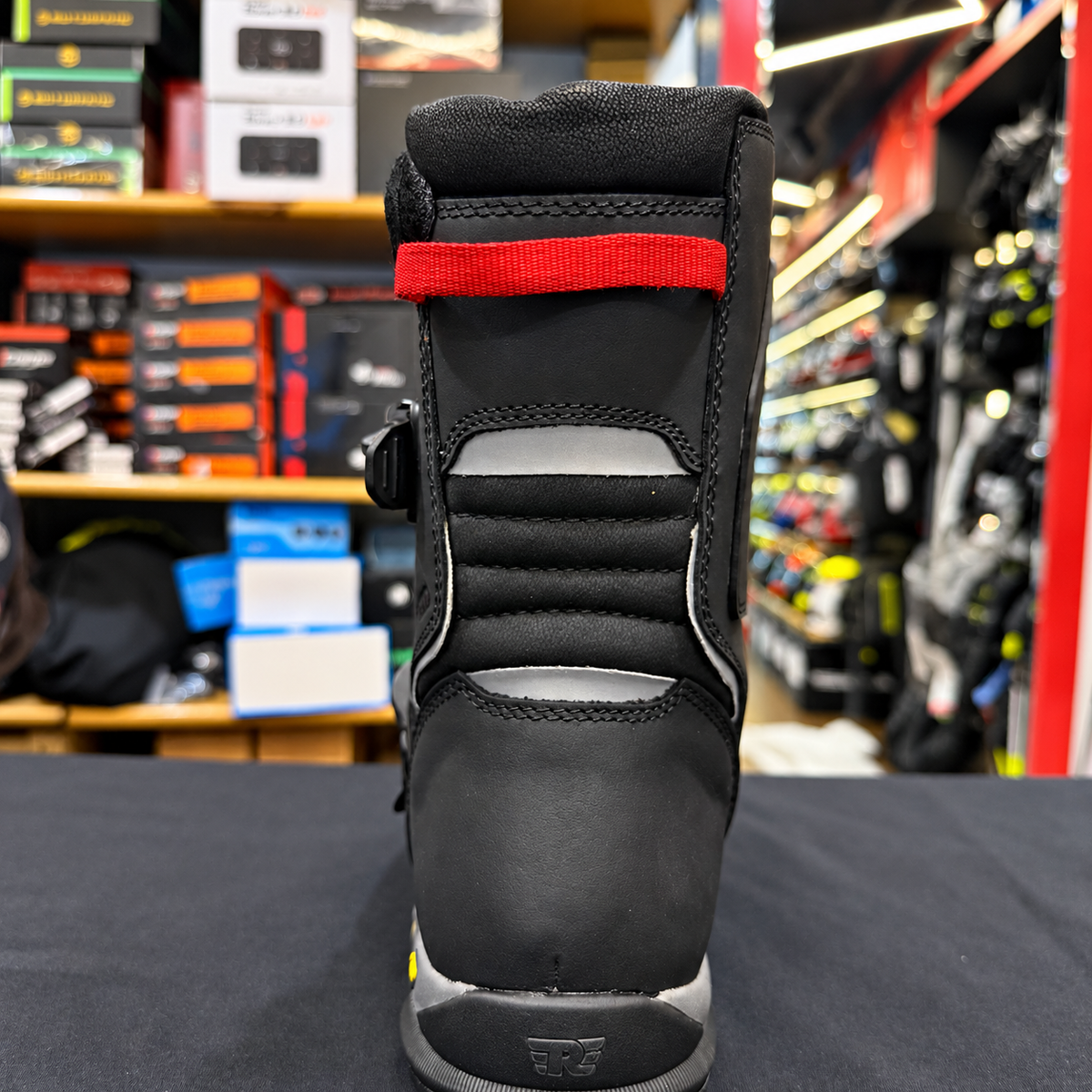 Black Royal Enfield Wanderer waterproof riding boot, rear view showing red pull loop, padded ankle and reflective panels.